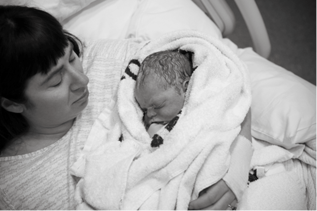 A photo of Nicola Devine in bed with her  son, Tanner, who was still born.