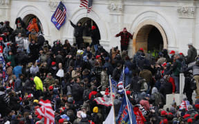 Supporters of US President Donald Trump storm the US Capitol during a rally to contest the certification of the 2020 US presidential election results.