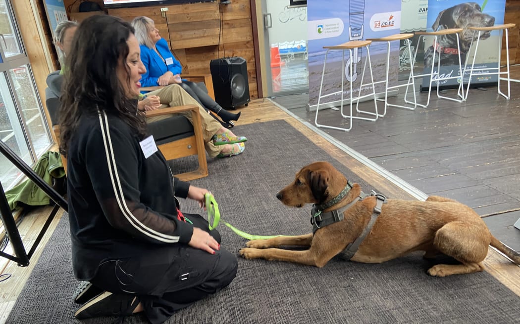 Maria Alomajan training a dog  - part of DOC's campaign Lead the Way