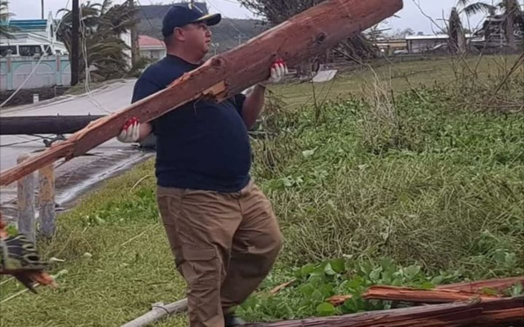 Governor Ralph Torres assists with the clean-up effort after Typhoon Mangkhut