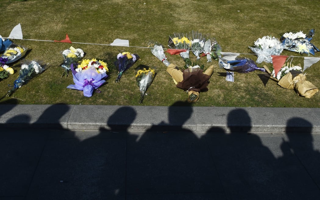 A crowd gathers to look at flowers placed at the site of the New Year's Eve stampede at the Bund in Shanghai.
