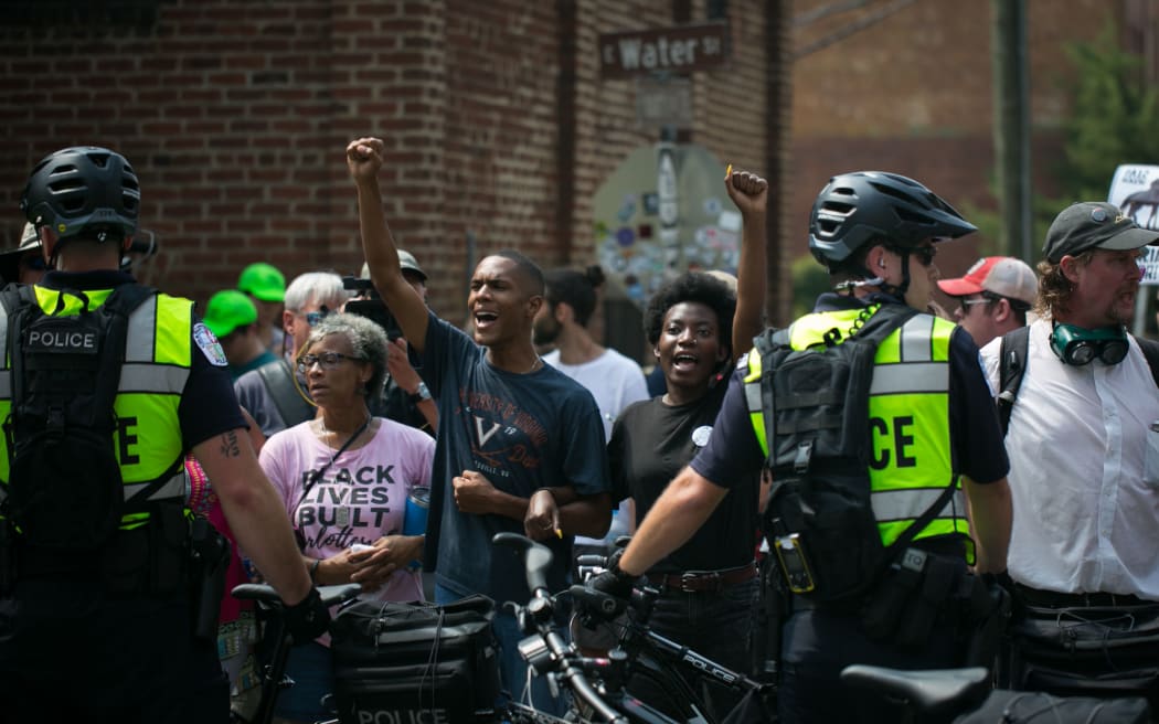 Virginia State Police block chanting protestors in Charlottesville.