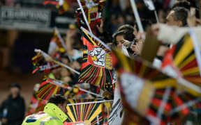 Chiefs rugby supporters wave flags at a match against the Hurricanes in 2012.