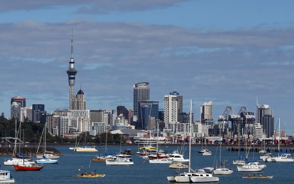Boats moored in waters in front of the Auckland city skyline: February 2014