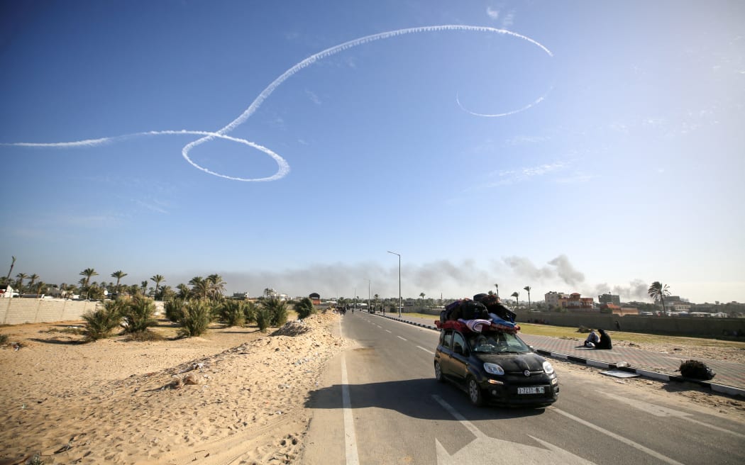 Palestinian families are fleeing the city on the coastal road leading to Rafah from the southern outskirts of Khan Yunis, in the southern Gaza Strip, amid ongoing battles between Israel and the Palestinian militant group Hamas, in Khan Yunis, Gaza Strip, on January 22, 2024. (Photo by Majdi Fathi/NurPhoto) (Photo by MAJDI FATHI / NurPhoto / NurPhoto via AFP)