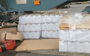 Containers for water near a tanker in Waikouaiti where high lead levels were discovered in the water supply.
