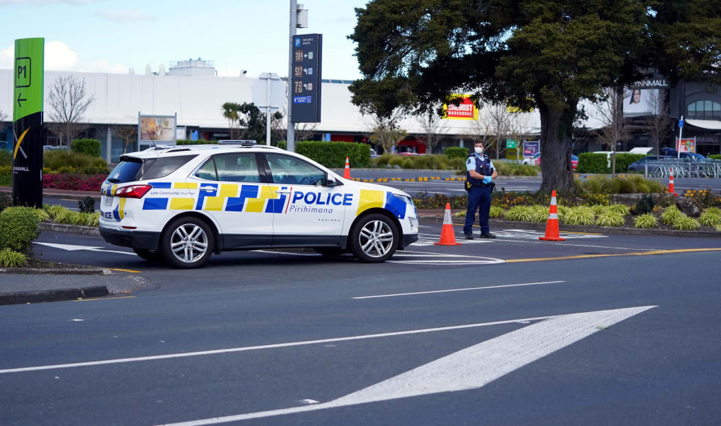 Police keep watch outside the Countdown supermarket at LynnMall.