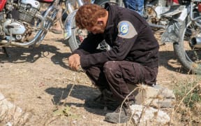 A member of the Syrian civil defence volunteers, also known as the White Helmets, mourns as colleagues bury his fellow comrades.