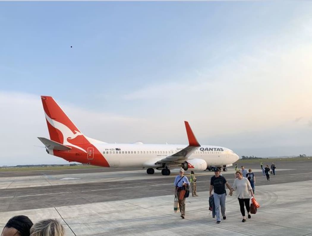 Passengers depart from the diverted Qantas plane.