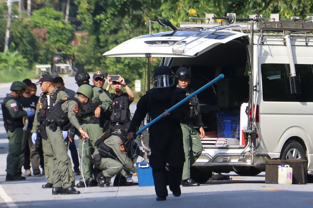 Members of a bomb squad inspect the site of an attack by suspected separatists in Yala province on November 6, 2019.