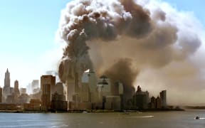 Clouds of smoke rise as the twin towers of the World Trade Center in New York crumble, 11.9.2001. The WTC skyscrapers collapsed following the suicide attacks of Islamic terrorists with highjacked planes, burying thousands of victims among the ruins.