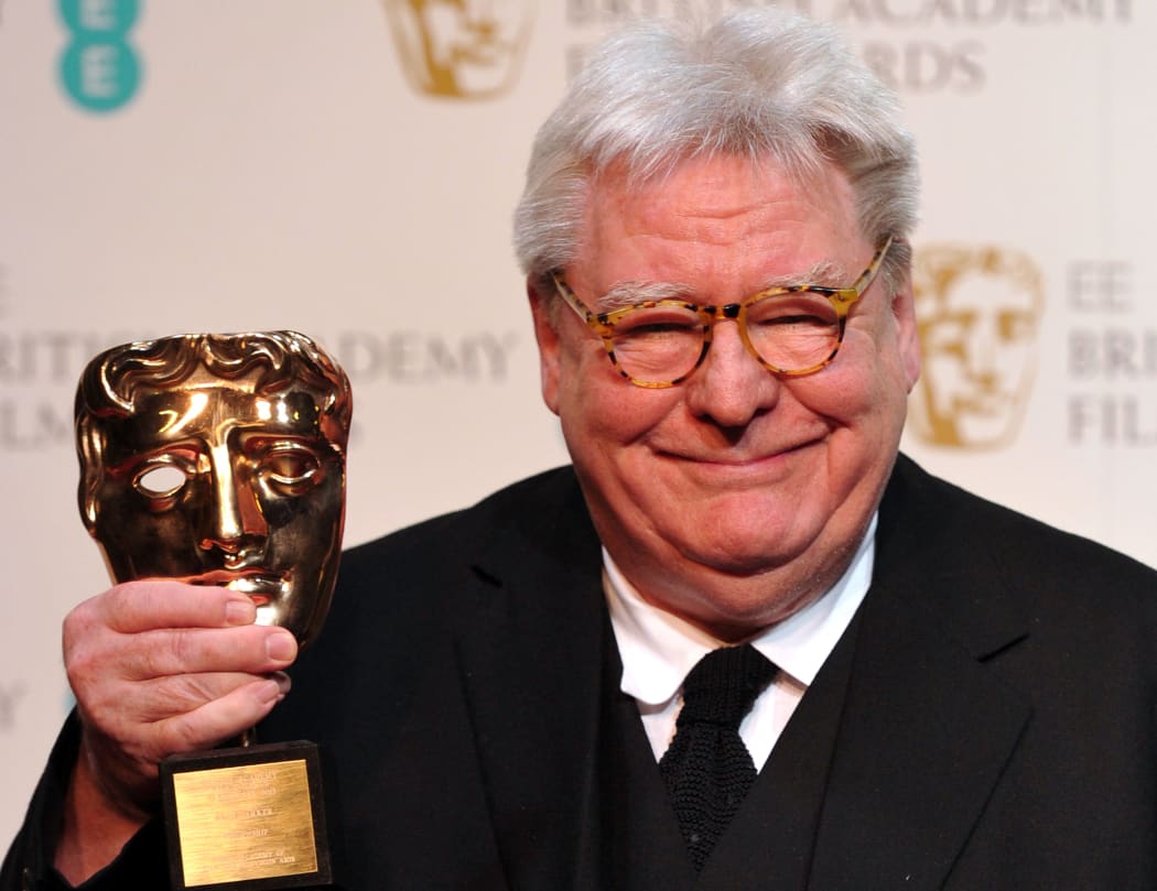 British film director, producer and writer Alan Parker poses with his BAFTA fellowship award during the annual BAFTA British Academy Film Awards at the Royal Opera House in London on February 10, 2013.