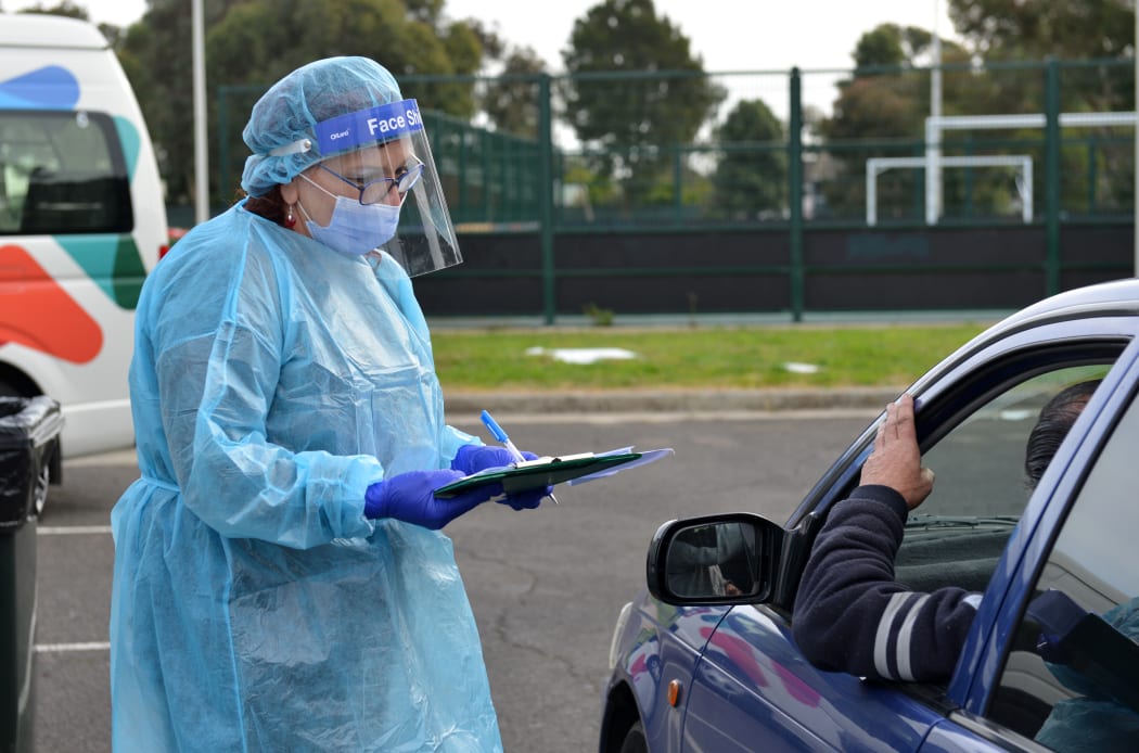 Health officials check people at a Covid-19 testing centre in Melbourne