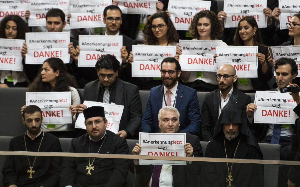Activists react after law makers voted to recognise the Armenian genocide in the lower house of the German Parliament.