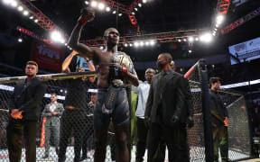 Israel Adesanya celebrates his successful title defence against Marvin Vettori.