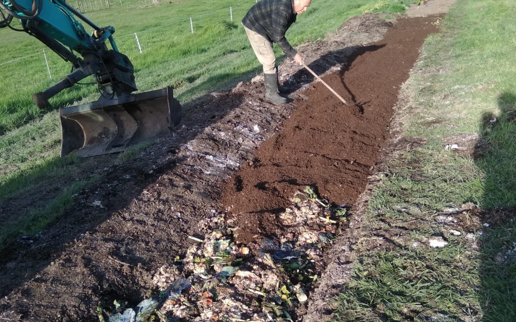 Food scraps line a planting bed which is then topped with compost, creating healthy topsoil from waste