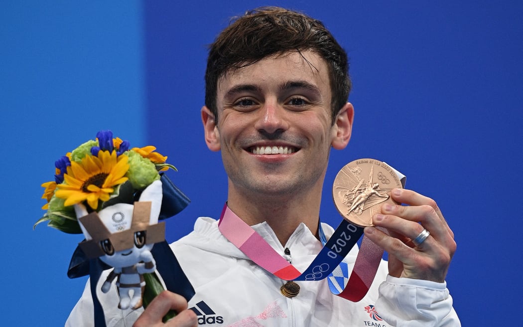 Bronze medallist Britain's Thomas Daley poses with their medal during the medal presentation ceremony after the men's 10m platform diving final event during the Tokyo 2020 Olympic Games at the Tokyo Aquatics Centre in Tokyo on August 7, 2021.