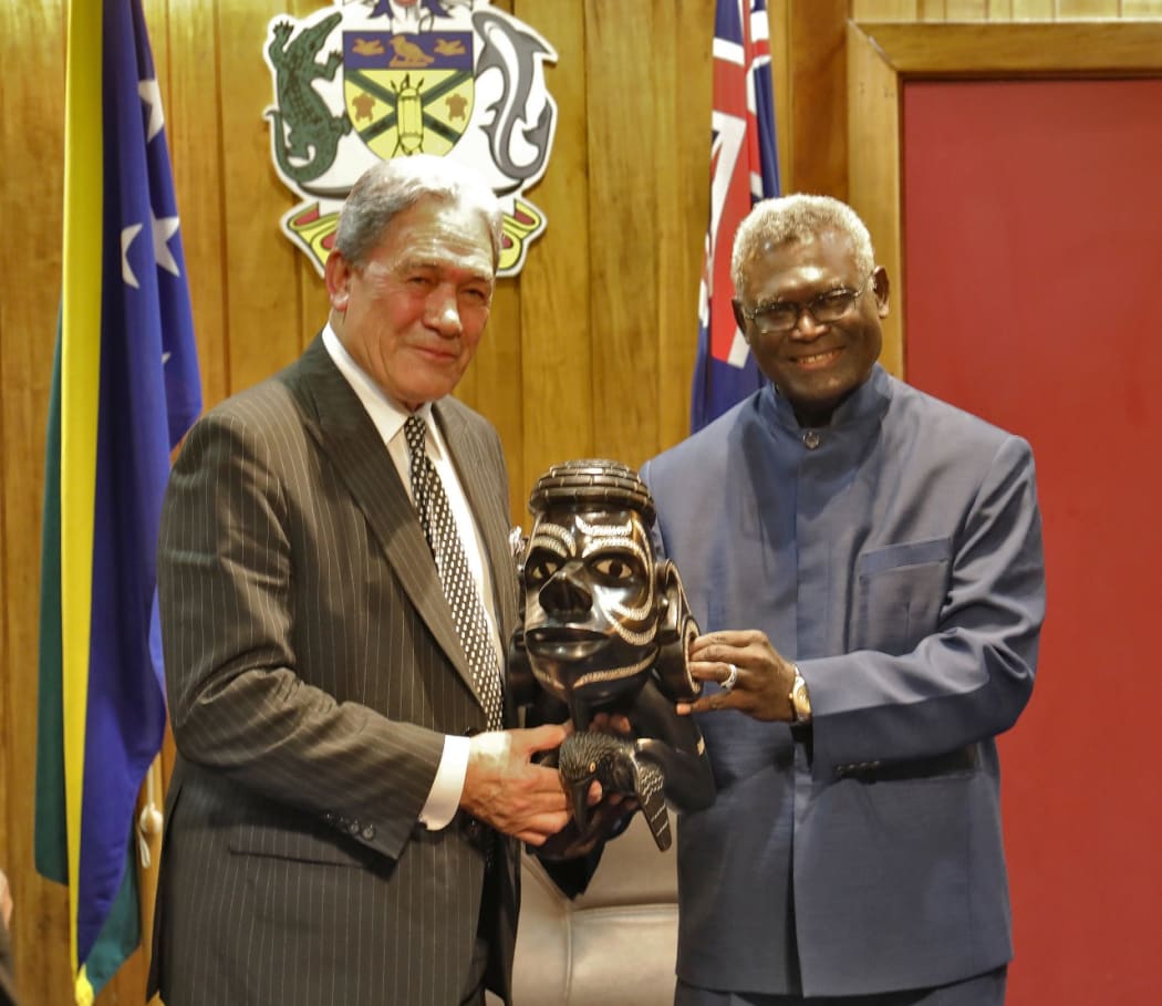 Solomon Islands prime minister (right) Manasseh Sogavare presents a Nguzu Nguzu to New Zealand's deputy prime minister Winston Peters. June 2019