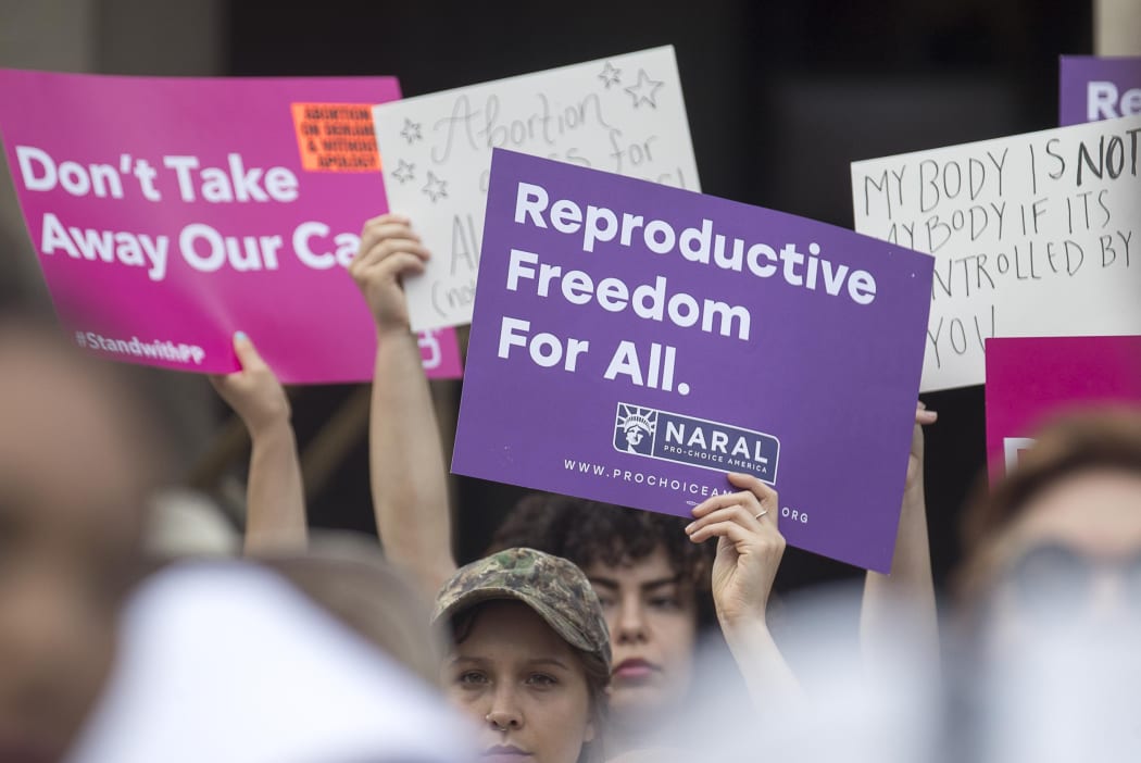 Protestors rally outside the Georgia State Capitol following the signing of legislation banning abortions once a foetal heartbeat.