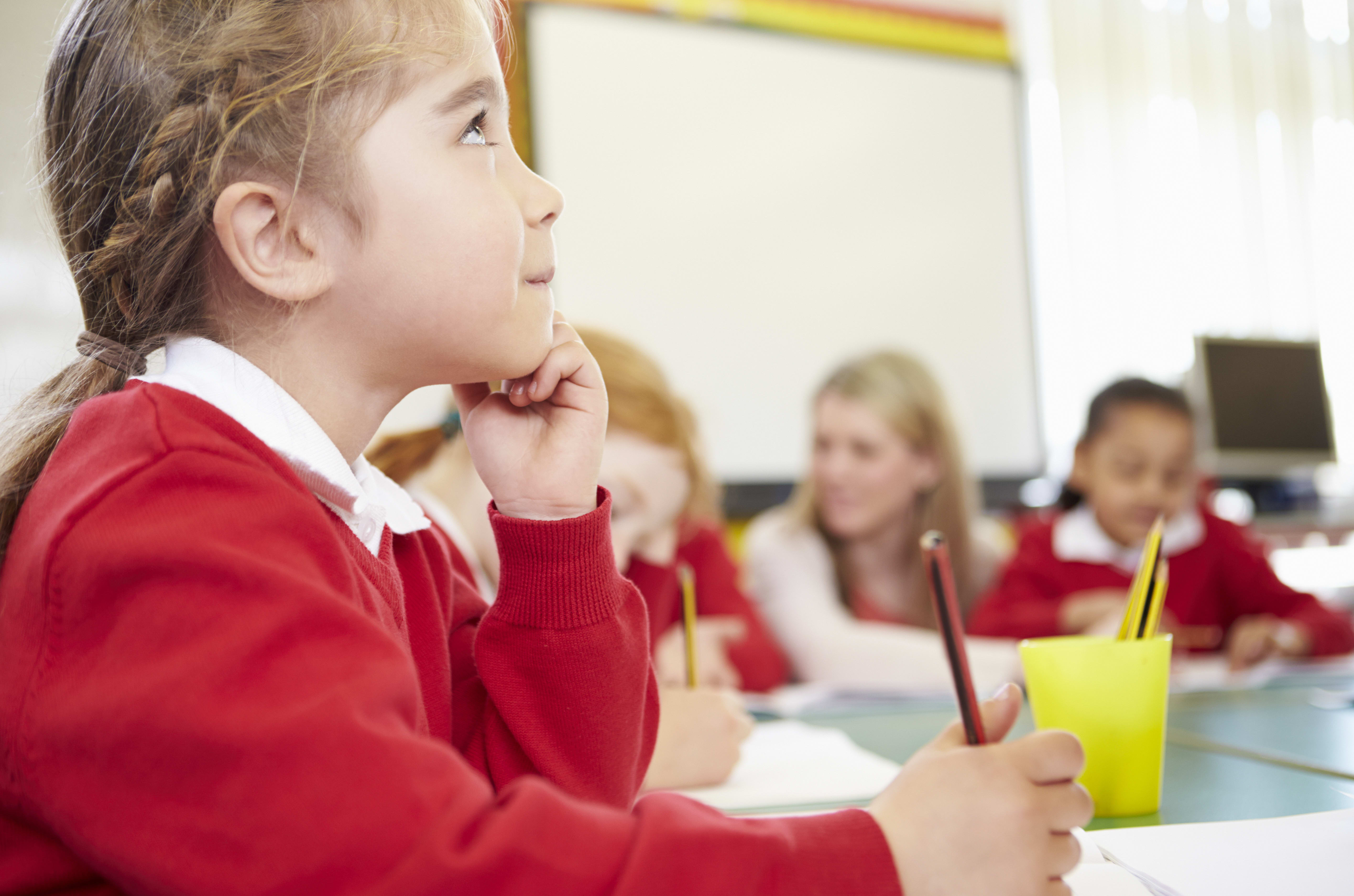 Female Elementary Pupil Working At Desk