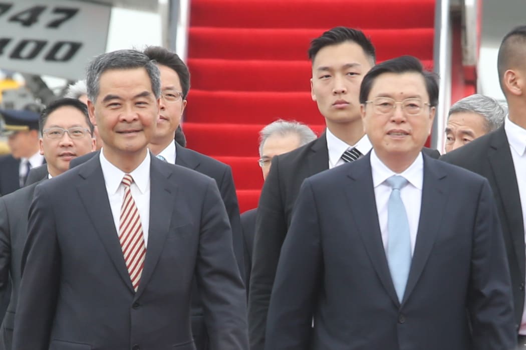 The National People's Congress Standing Committee Chairman, Zhang Dejiang (right), 69, arrives in Hong Kong.