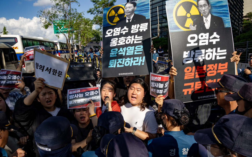 Members of The Korean University Students Progressive Union participate in a rally against the release of treated radioactive water from the Fukushima nuclear power plant, Japan into the Pacific Ocean, outside the Japanese Embassy on August 25, 2023 in Seoul, South Korea.  (Photo by Chris Jung/NurPhoto) (Photo by Chris Jung / NurPhoto / NurPhoto via AFP)