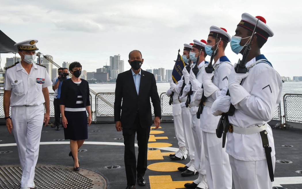 (L-R) Joint Commander of the French Armed Forces in the Asia Pacific Rear Admiral Jean-Mathieu Rey, French Ambassador to the Philippines Michèle Boccoz, and Philippines' Defense Secretary Delfin Lorenzana walk on the deck of the French navy's frigate Le Vendémiaire