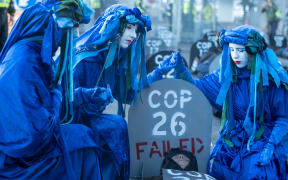 Extinction Rebellion members mourn what they called COP26's failure in Glasgow.