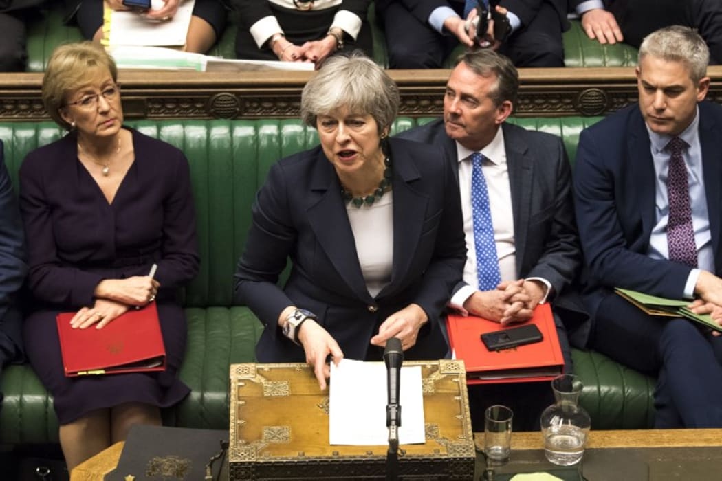 A handout photograph released by the UK Parliament on March 13, 2019 shows Britain's Prime Minister Theresa May responding to the result of a vote in the House of Commons in London