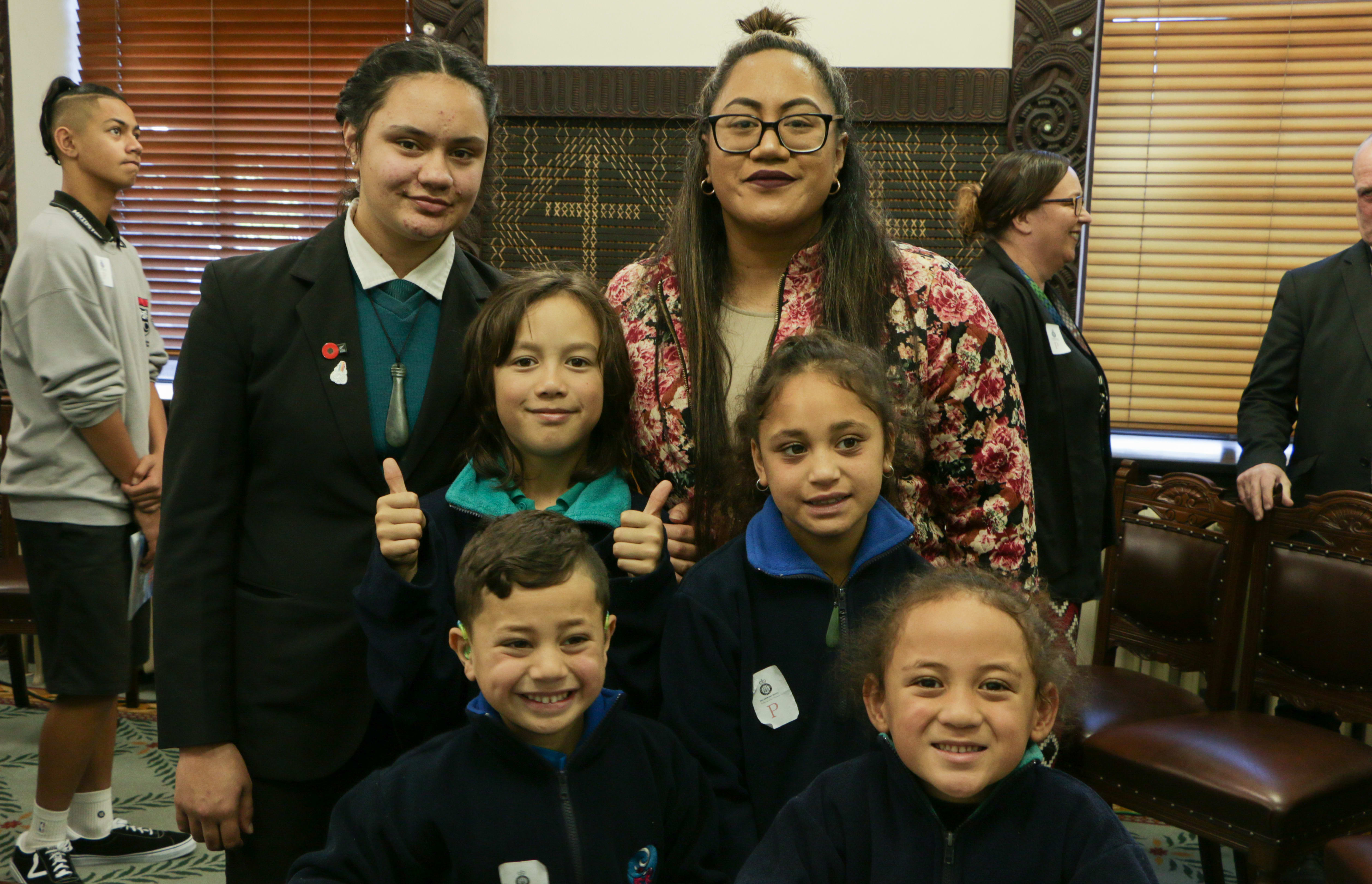 Tamariki from Te Kura Kaupapa Māori o Ngā Mokopuna with Tupa Ora te reo Māori manager Tiare Teinakore (right).