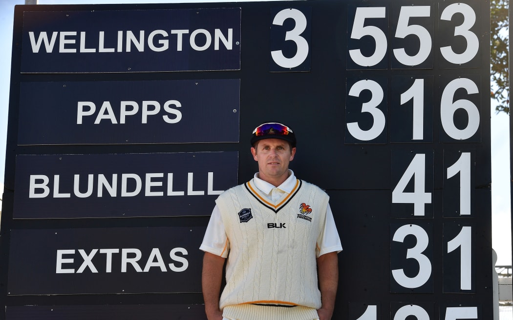 Michael Papps stands in front of the score board after scoring 316 not out for Wellington against Auckland in a Plunket Shield match at the Basin Reserve in October 2017.