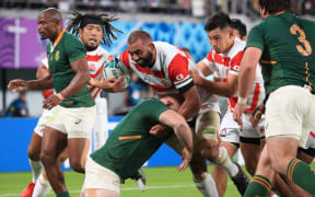 Michael Leitch of Japan struggles to hold a ball during the 2019 Rugby World Cup Japan Quarter-Finals match against South Africa at Tokyo Stadium in Chofu City, Tokyo on October 20, 2019.
