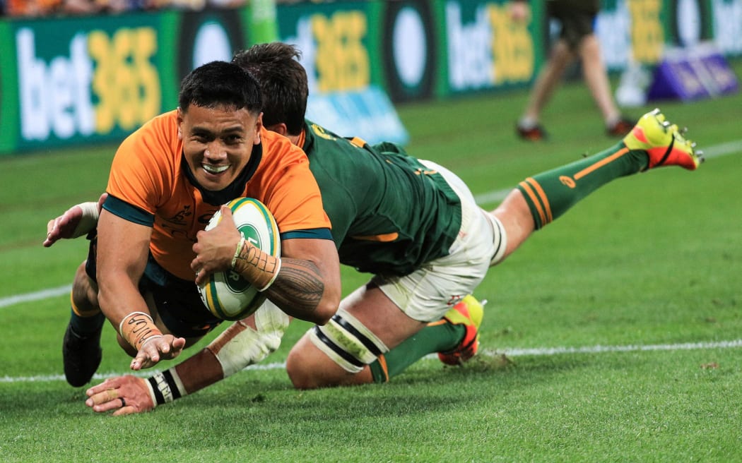 Wallabies centre Len Ikitau scores.