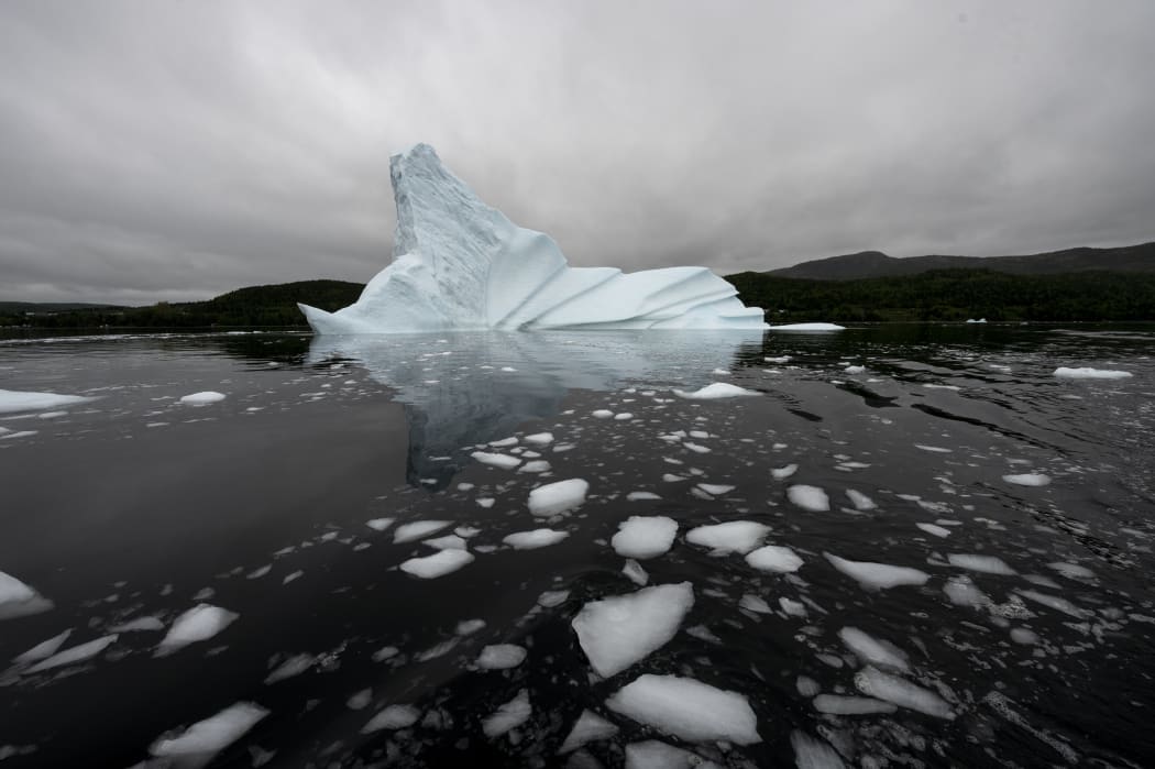 An iceberg floats off King's Point on July 3, 2019 in Newfoundland, Canada. The abundance of icebergs, which continue to venture further into Canadian waters, has created a new form of tourism, iceberg sightseeing.