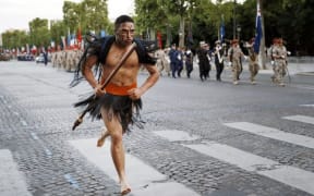 New Zealand Defence Force personnel march down the Champs Elysees in Paris during a rehearsal of the annual Bastille Day military parade.
