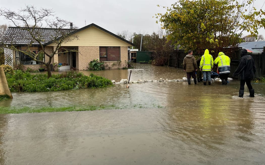 A Hathaway St resident put sandbags down on Friday but to no avail.