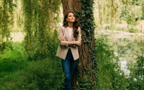 A new photo of the princess, showing Kate standing under a tree on the Windsor estate to the west of London, where the family home is located.