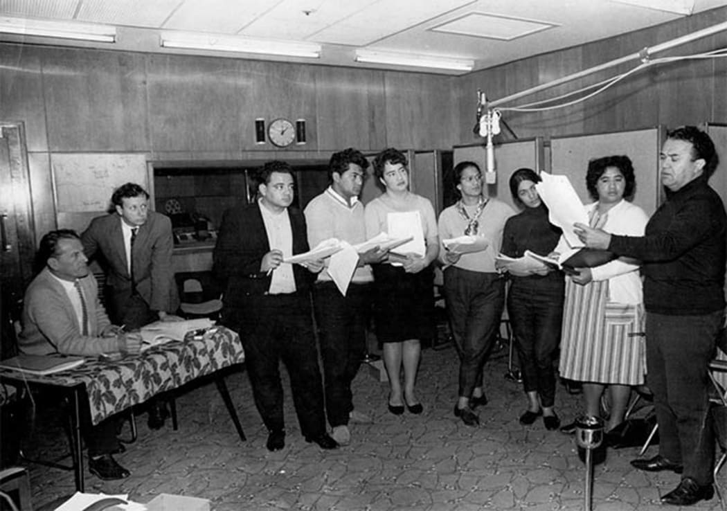 The cast record the play in the production studios at Broadcasting House, Wellington, in 1965. Those shown are, from left: William Austin, producer; Bruce Mason, playwright; and cast members Don Selwyn, Sam Stevens, Ngaire Karaka, Hannah Tatana, Diana Winterburn, Newha Taiaki and Īnia Te Wīata