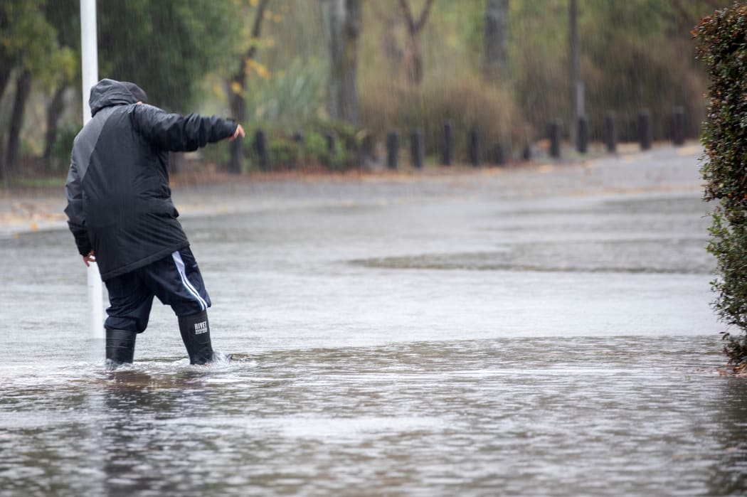 A man walks through the flood waters in Christchurch, NewÂ Zealand on May 30, 2021.Â MetService has put in place code red severe weather warning for the Canterbury region. (Photo by Sanka Vidanagama/NurPhoto via Getty Images)