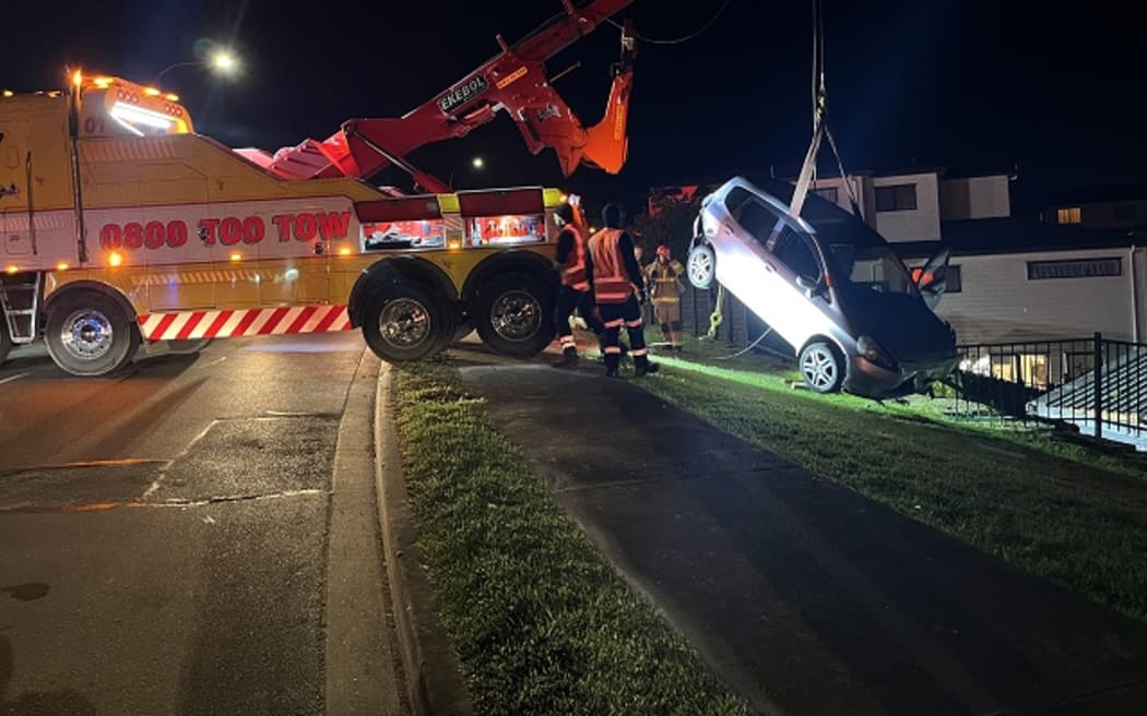 A man will appear in Court after allegedly driving his car into a house in Albany and becoming suspended three metres above the ground.