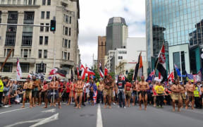 Protesters arrive at the bottom of Queen St after marching