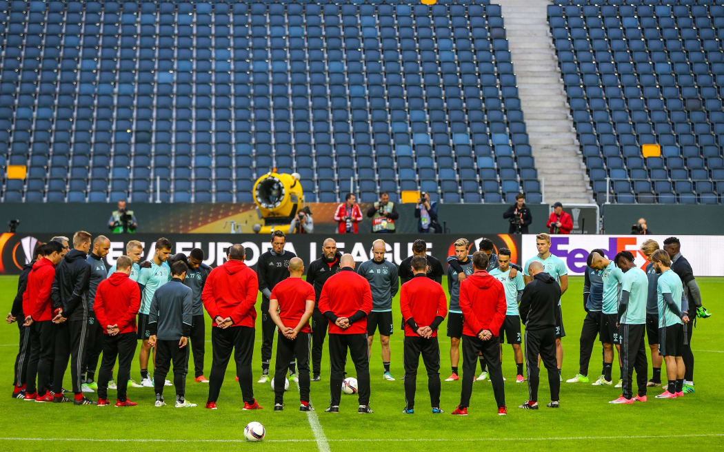 Ajax footballers stand in silence for the victims of the Manchester Arena explosion in training ahead of the UEFA Europa League final against Manchester United at Friends Arena in Solna outside Stockholm, Sweden.
