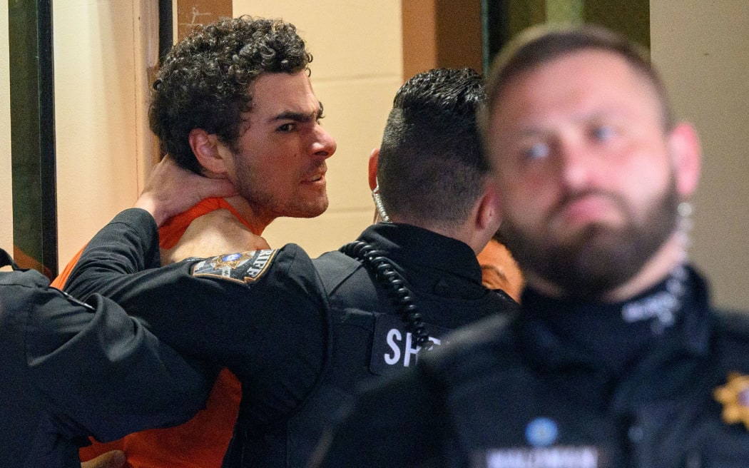 Luigi Mangione is led into the Blair County Courthouse for an extradition hearing Tuesday in Hollidaysburg, Pennsylvania.