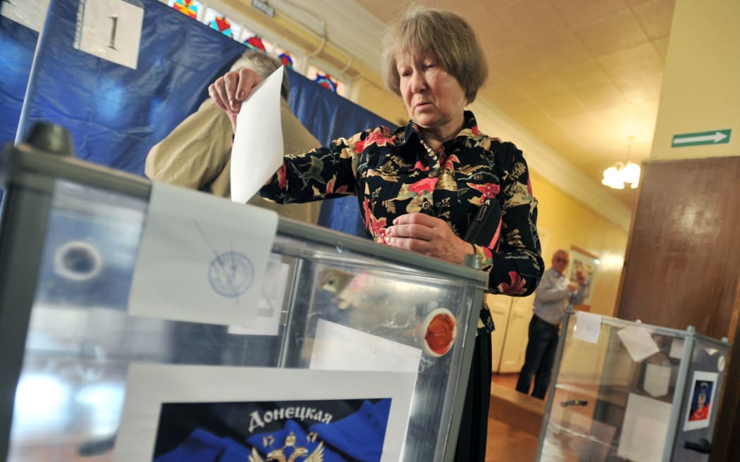A woman casts her ballot in a polling booth at Donetsk.