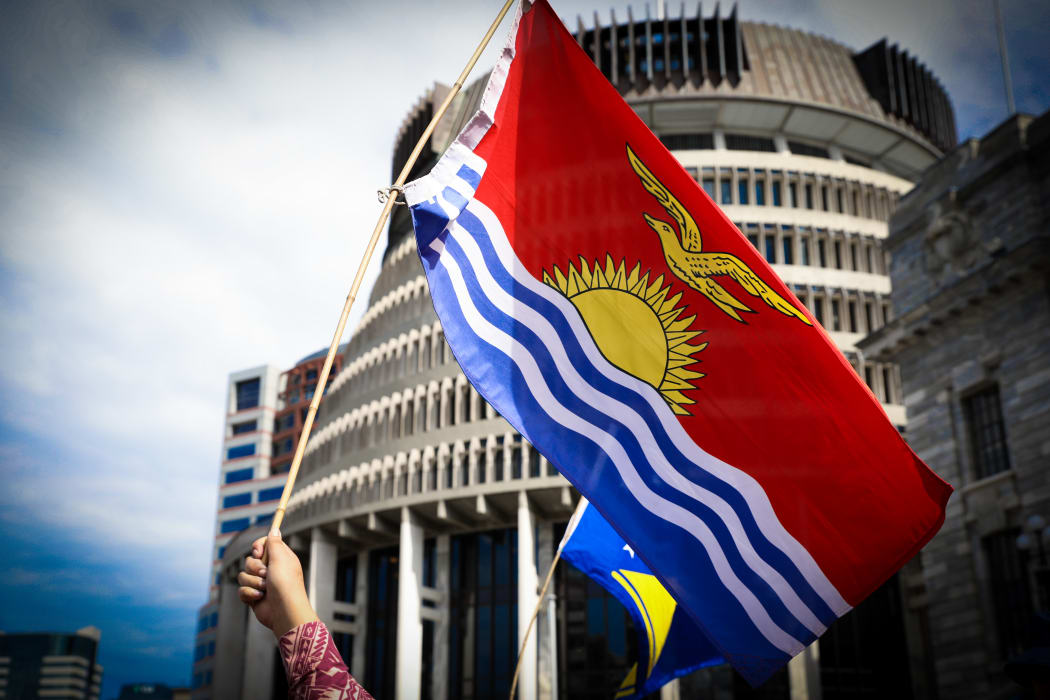 The Kiribati flag is waved in front of the Beehive in Wellington.