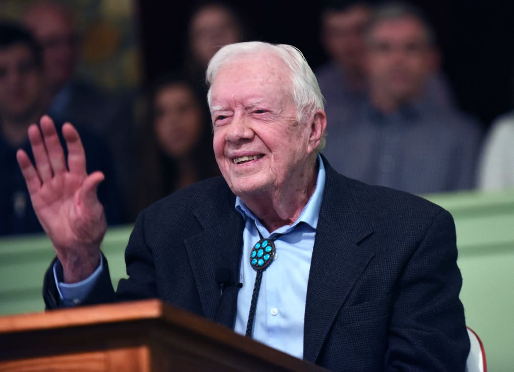 Former U.S. President Jimmy Carter waves to the congregation after teaching Sunday school at Maranatha Baptist Church in his hometown of Plains, Georgia on April 28, 2019. Carter, 94, has taught Sunday school at the church on a regular basis since leaving the White House in 1981, drawing hundreds of visitors who arrive hours before the 10:00 am lesson in order to get a seat and have a photograph taken with the former President and former First Lady Rosalynn Carter.  (Photo by Paul Hennessy/NurPhoto) (Photo by Paul Hennessy / NurPhoto / NurPhoto via AFP)