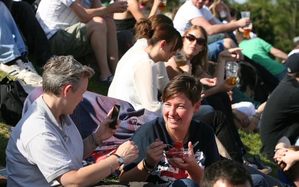 Spectators enjoy their traditional strawberries and cream along with Pimms and beers at Wimbledon.