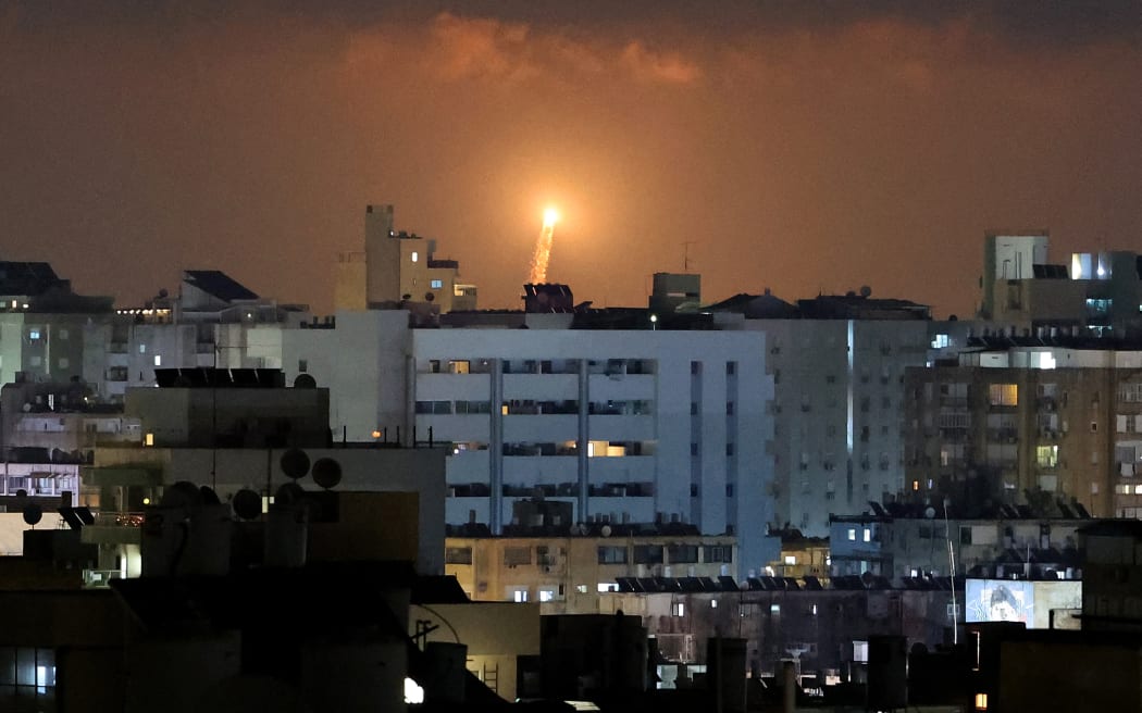 Rocket trails are seen in the sky above the Israeli coastal city of Netanya amid a fresh barrage of Iranian missile attacks on June 17, 2025. Israel and Iran exchanged fire again on June 17, the fifth day of strikes in their most intense confrontation in history, fuelling fears of a drawn-out conflict that could engulf the Middle East. (Photo by JACK GUEZ / AFP)