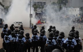 Riot police fire tear gas to protesters outside the Legislative Council in Hong Kong, Wednesday, June 12, 2019.