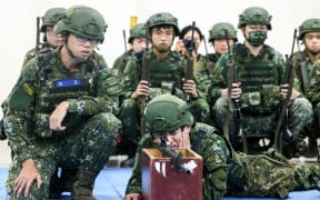 Taiwanese reservists participate in pre-combat training on the first day of the annual Han Kuang military exercise in Miaoli on July 9, 2025. Taiwan will kick off its annual military drills on July 9, with newly delivered US high-tech rocket systems to feature in exercises aimed at preparing the self-ruled island for a Chinese attack. (Photo by I-Hwa Cheng / AFP)